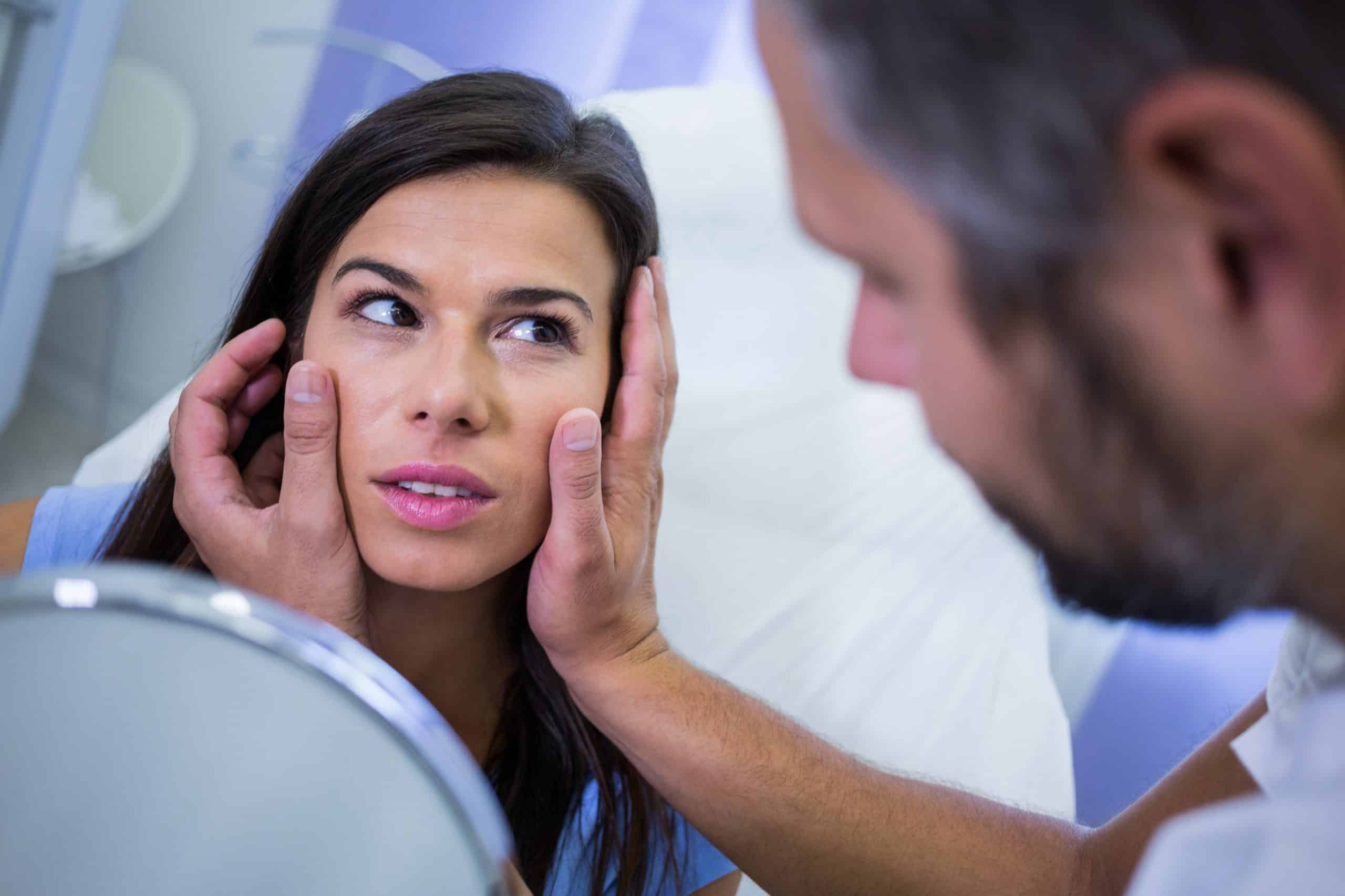 doctor checking patients skin after cosmetic treatment scaled